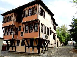 Red Revival-era house with large bay windows